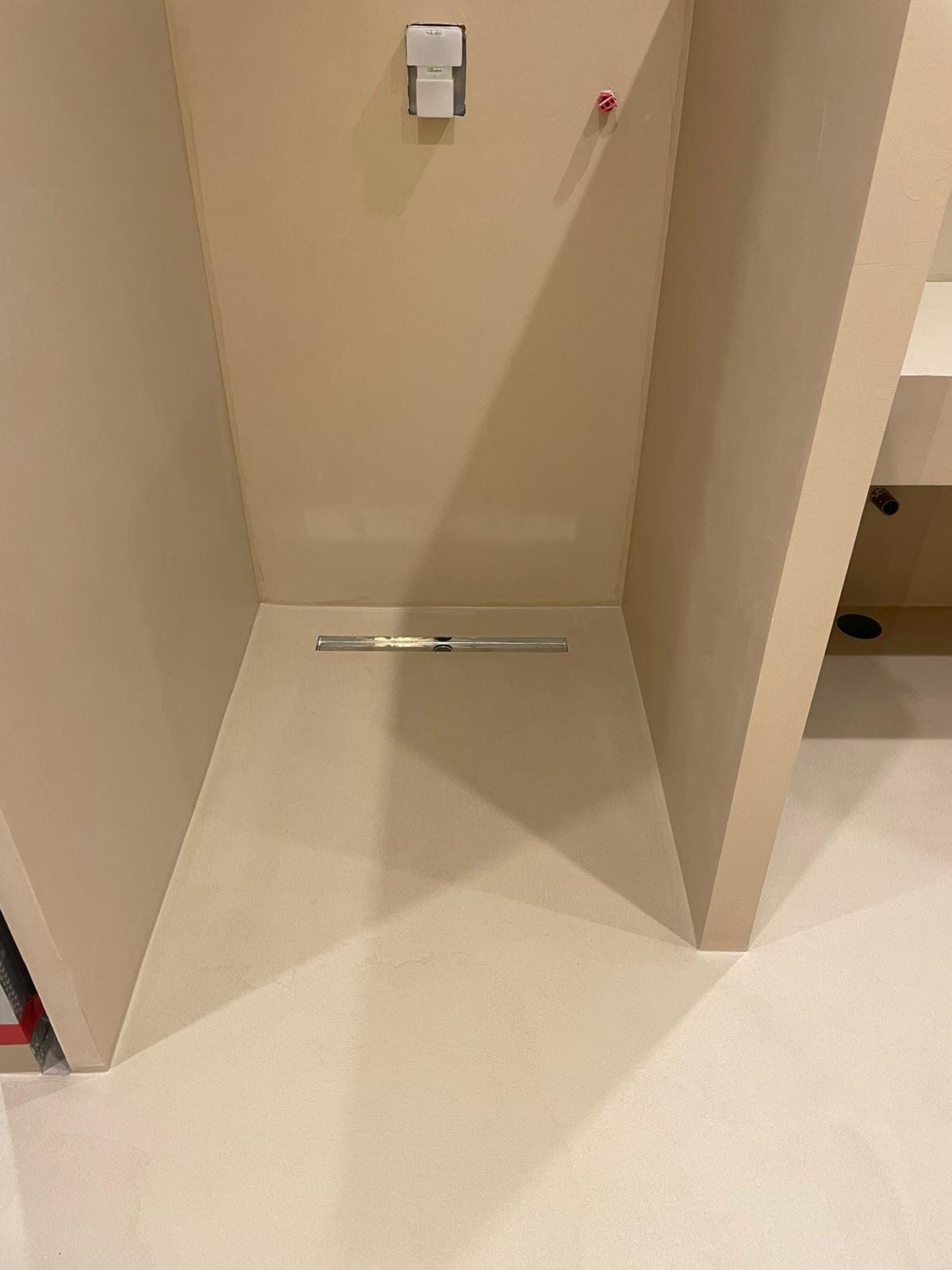 Finished microcement shower with a linear drain, Camel tone